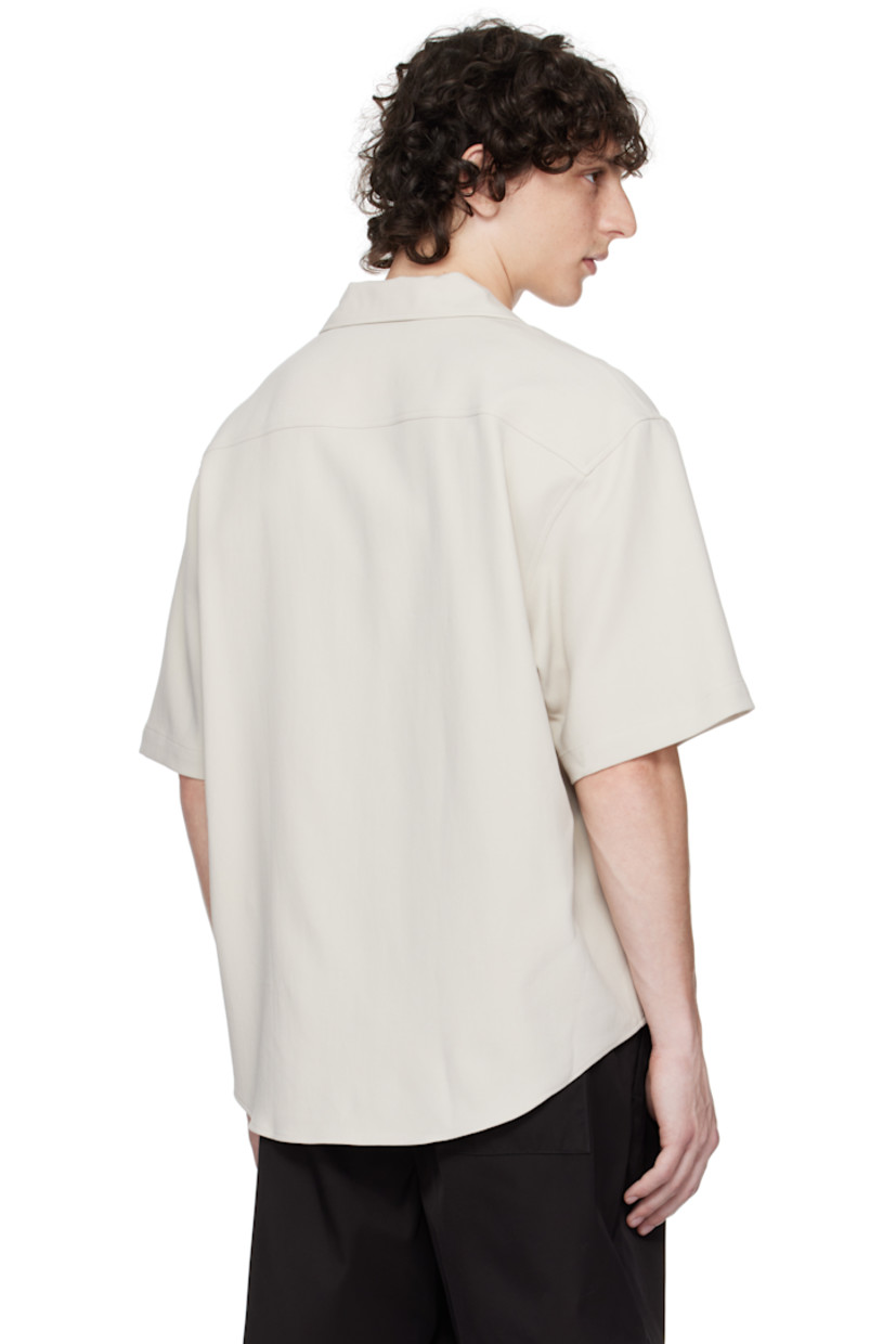 Cotton gabardine shirt.

· Open-spread collar
· Button closure
· Logo embroidered at patch pocket
· Shirttail hem
· Mother-of-pearl hardware

Supplier color: Mastic