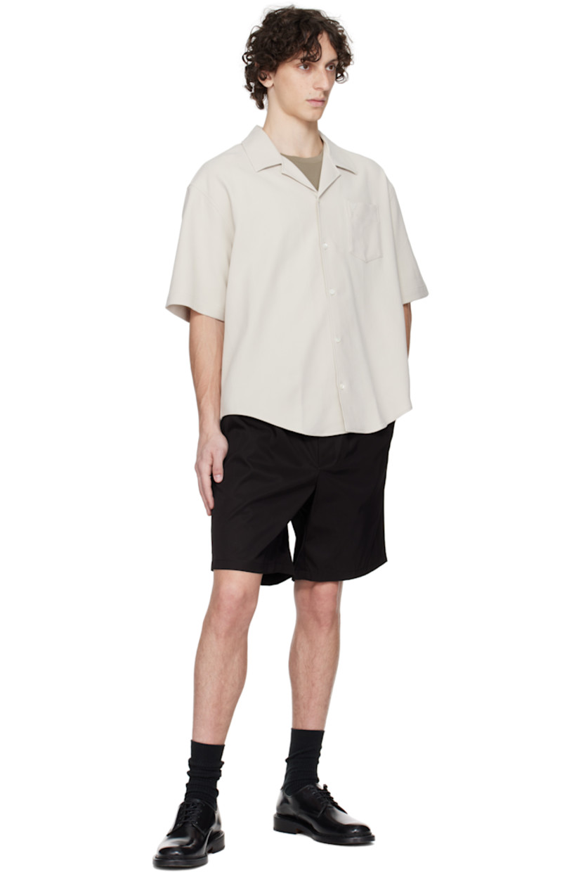 Cotton gabardine shirt.

· Open-spread collar
· Button closure
· Logo embroidered at patch pocket
· Shirttail hem
· Mother-of-pearl hardware

Supplier color: Mastic