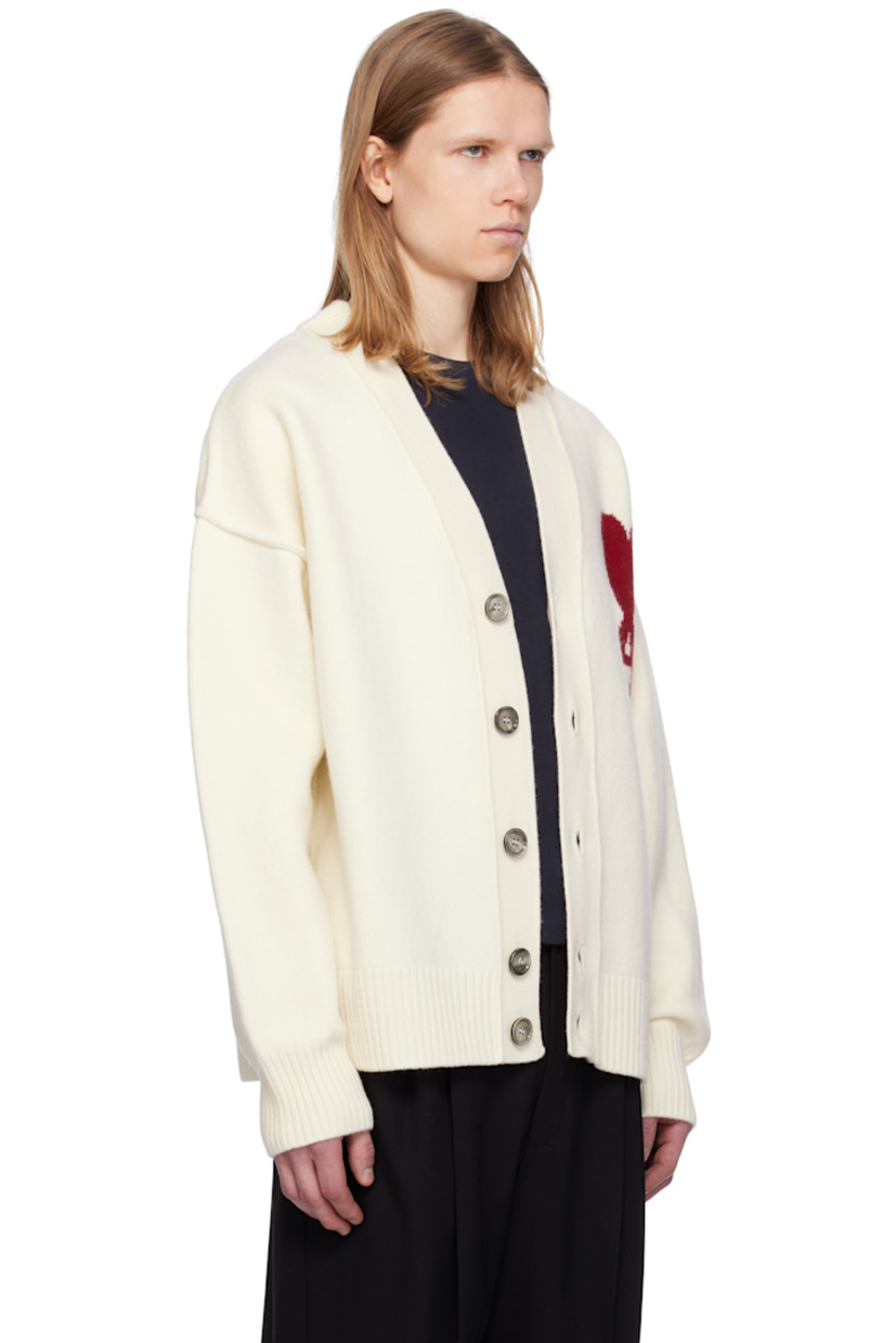 Felted knit virgin wool cardigan. Inverted seams throughout.

· Rib-knit Y-neck, hem, and cuffs
· Button closure
· Intarsia logo at chest
· Dropped shoulders

Supplier color: Off white/Red