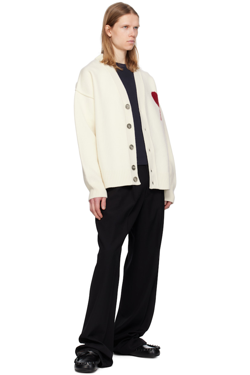 Felted knit virgin wool cardigan. Inverted seams throughout.

· Rib-knit Y-neck, hem, and cuffs
· Button closure
· Intarsia logo at chest
· Dropped shoulders

Supplier color: Off white/Red