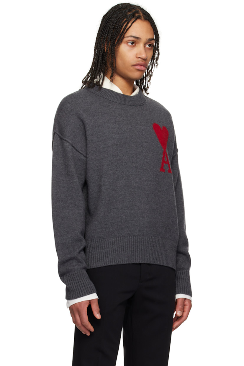 Felted knit virgin wool sweater. Raised seams throughout.

· Rib-knit crewneck, hem, and cuffs
· Intarsia logo at chest
· Dropped shoulders

Supplier color: Heather grey/Red
