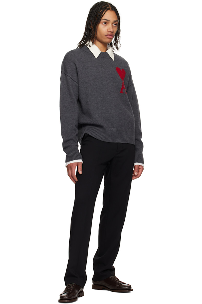 Felted knit virgin wool sweater. Raised seams throughout.

· Rib-knit crewneck, hem, and cuffs
· Intarsia logo at chest
· Dropped shoulders

Supplier color: Heather grey/Red