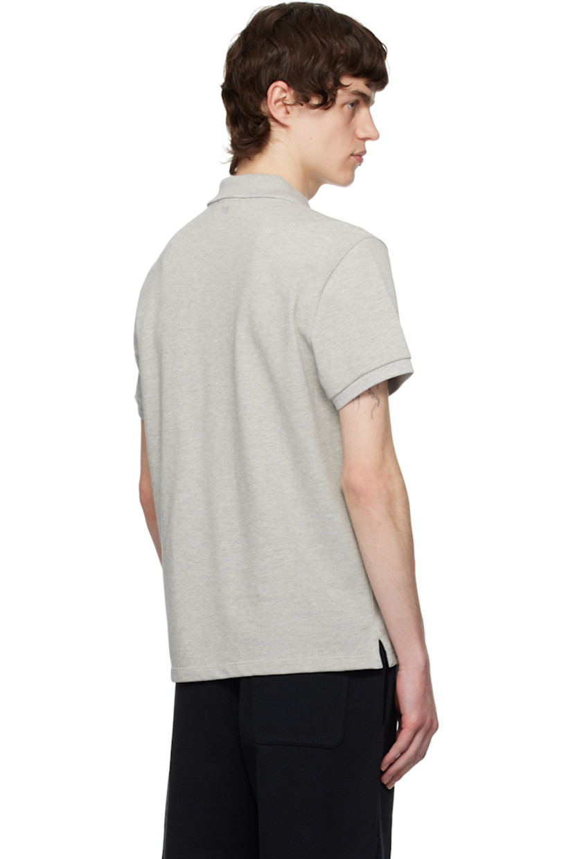 Organic cotton piqué polo. 

· Rib-knit spread collar and cuffs
· Two-button placket
· Logo embroidered at chest and back collar
· Tennis-tail hem

Supplier color: Heather ash grey