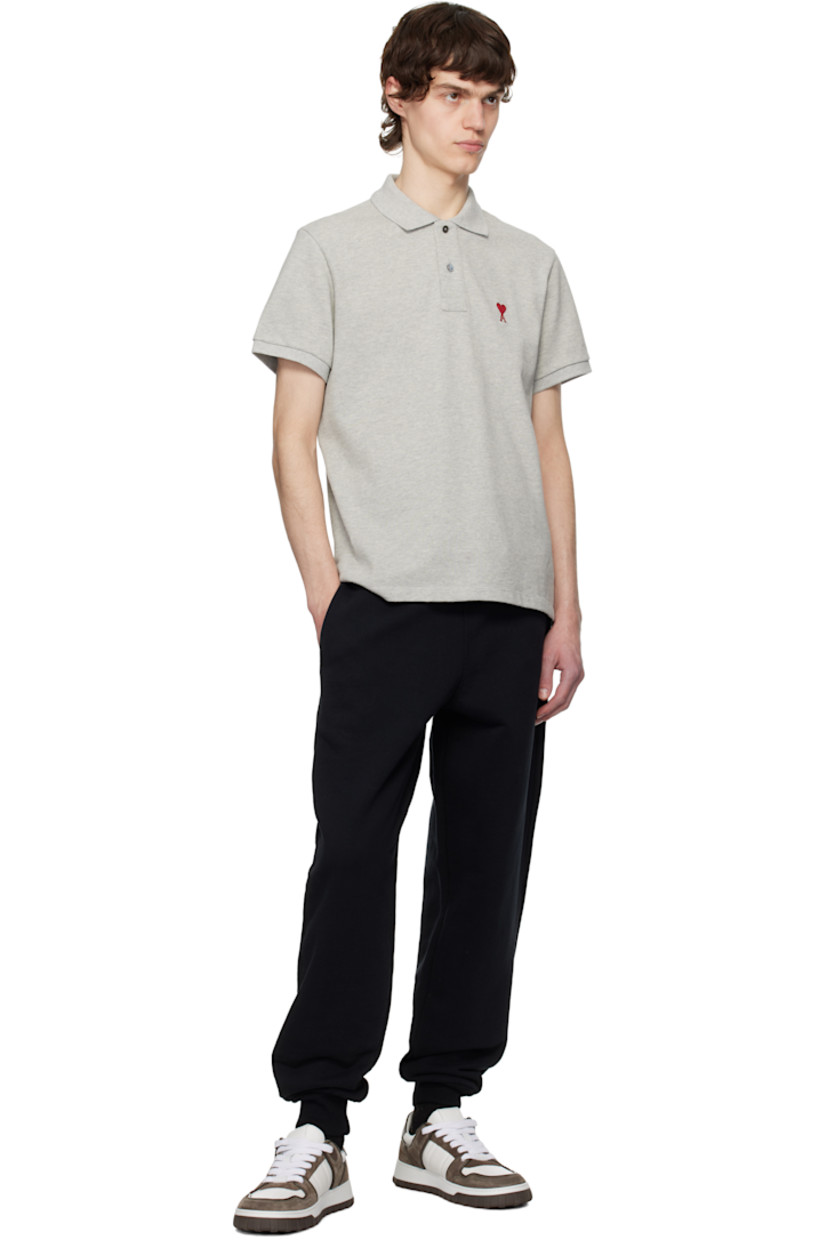 Organic cotton piqué polo. 

· Rib-knit spread collar and cuffs
· Two-button placket
· Logo embroidered at chest and back collar
· Tennis-tail hem

Supplier color: Heather ash grey