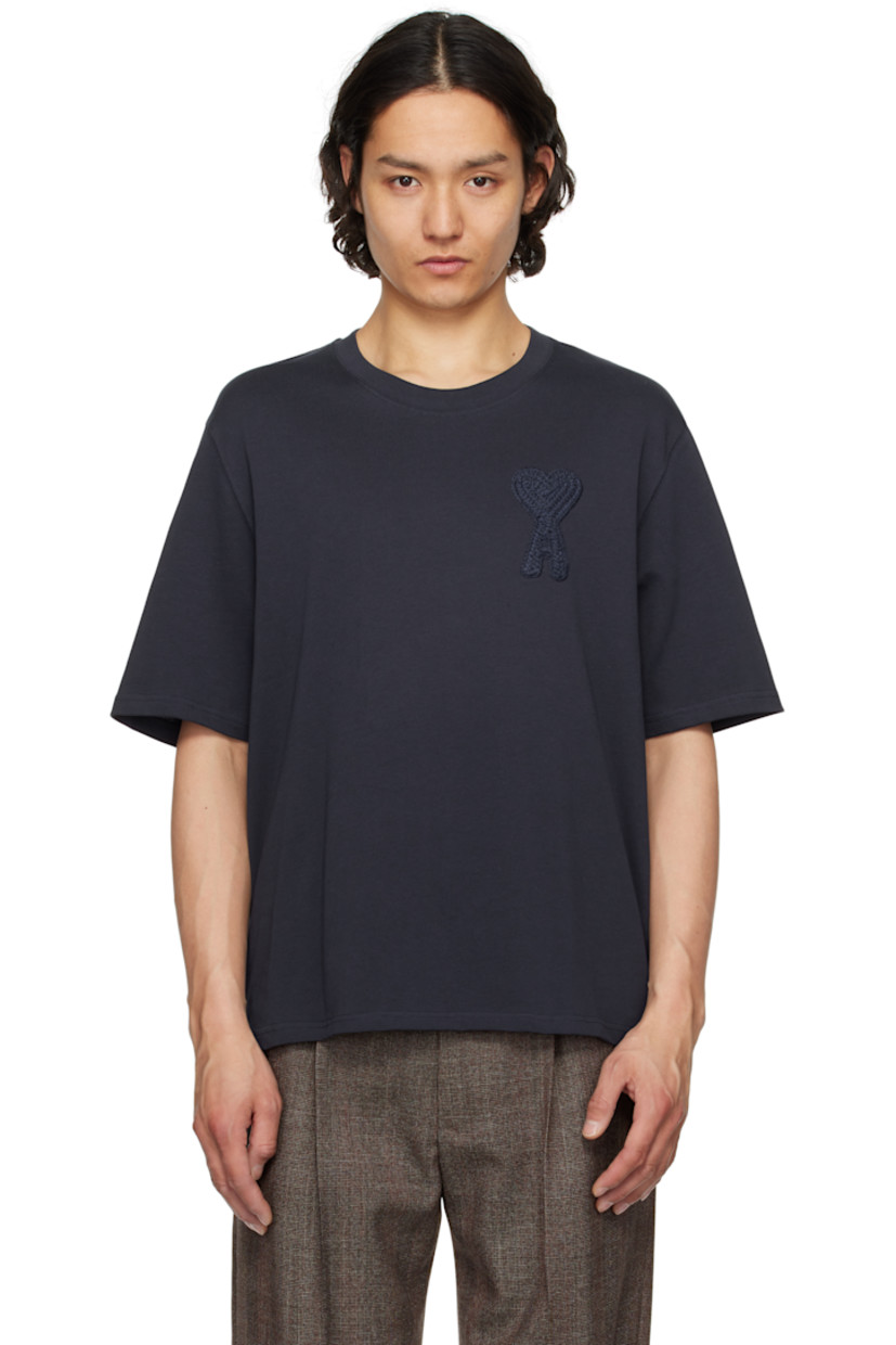 Organic cotton jersey T-shirt. 

· Rib-knit crewneck
· Woven logo appliqué at chest
· Dropped shoulders
· Logo embroidered at back collar

Supplier color: Navy blue