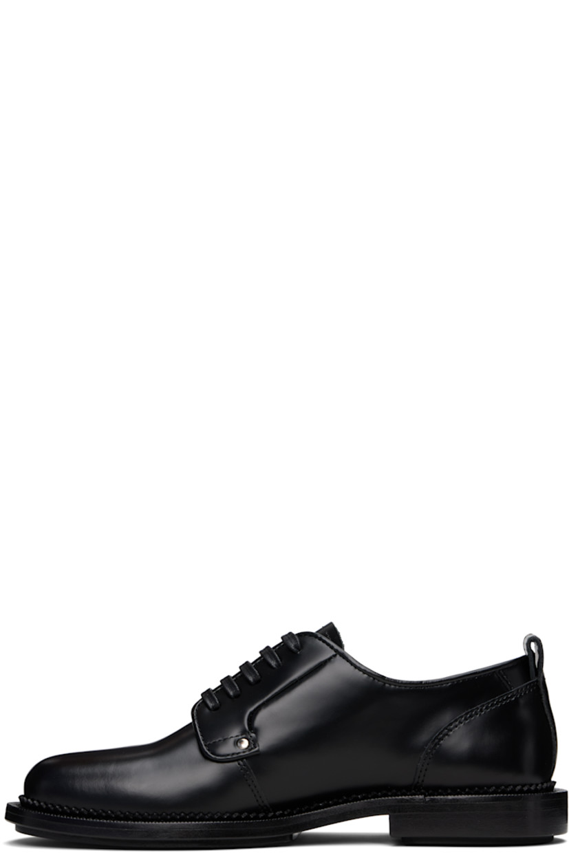 Polished and vegetable-tanned leather derbys in black.

· Lace-up closure
· Pull-loop at heel collar
· Serrated edge at welt
· Stacked leather heel with rubber injection
· Leather sole with rubber injection

Supplier color: Black