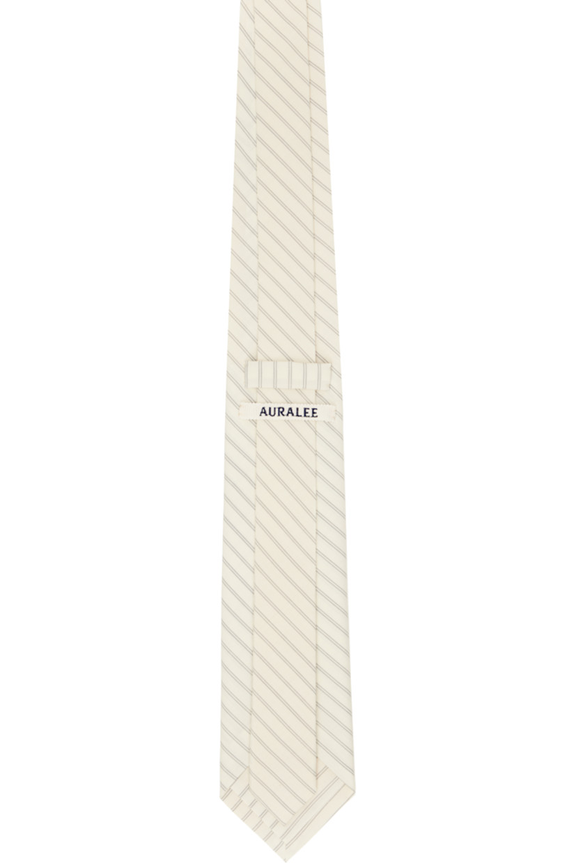 Lightweight super 180s plain-woven wool tie in off-white. 

· Stripes throughout
· Keeper loop at back face
· W3"

Supplier color: Ivory stripe
