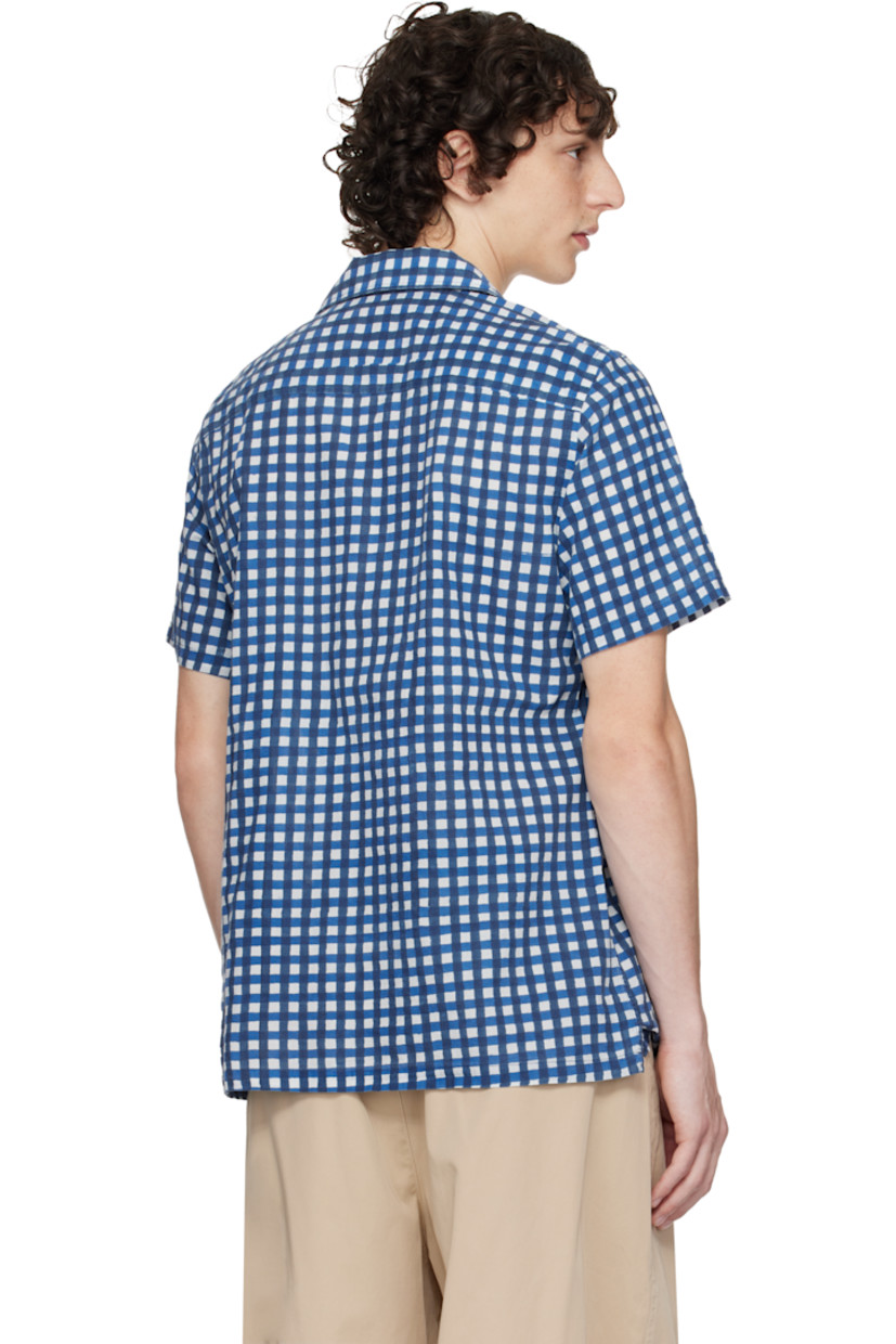 Plain-woven cotton shirt. 

· Gingham pattern printed throughout 
· Button tab at open spread collar 
· Button closure
· Flap pockets
· Vented side seams
· Mother-of-pearl hardware

Supplier color: Navy