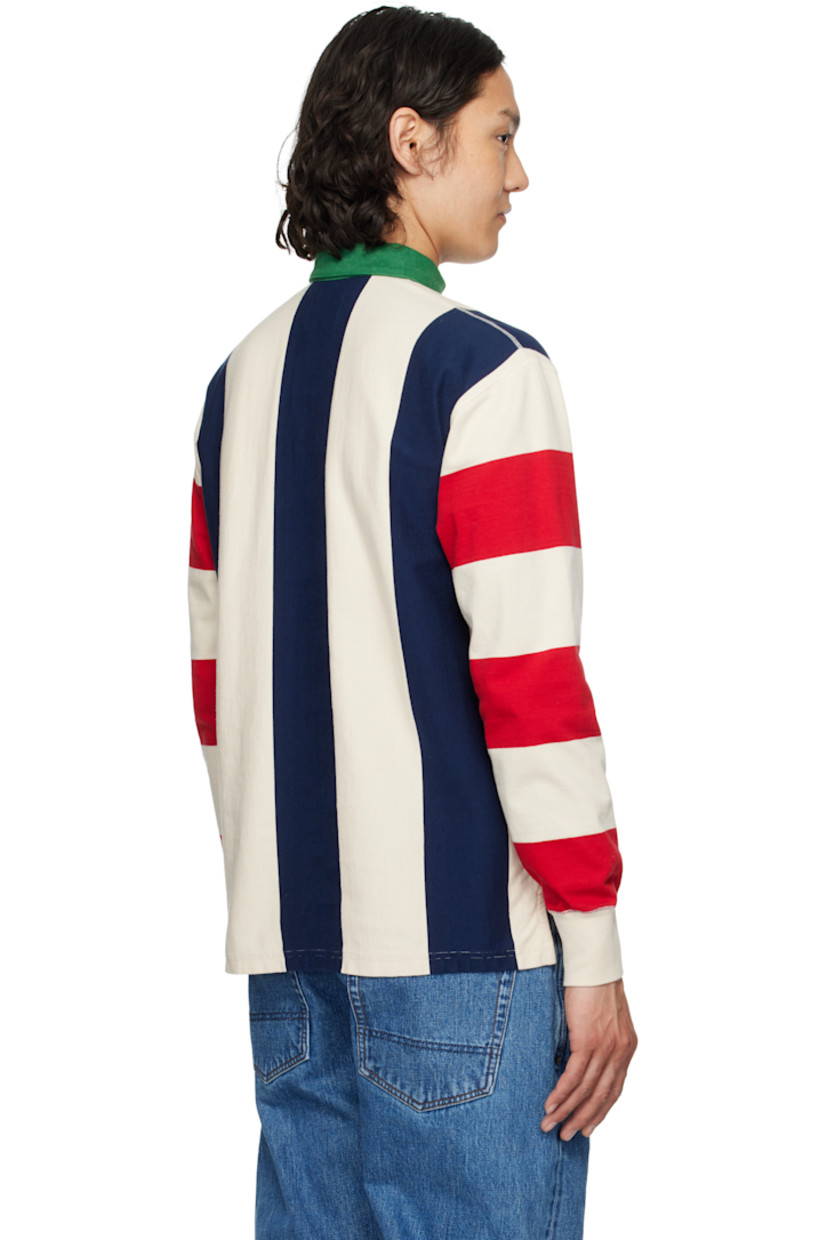 Knit cotton polo. Stripes throughout.

· Denim spread collar
· Concealed two-button placket
· Tennis-tail hem
· Rib-knit cuffs

Supplier color: Navy/Red/Ecru
