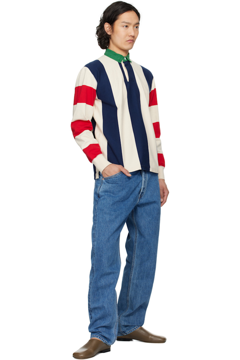 Knit cotton polo. Stripes throughout.

· Denim spread collar
· Concealed two-button placket
· Tennis-tail hem
· Rib-knit cuffs

Supplier color: Navy/Red/Ecru