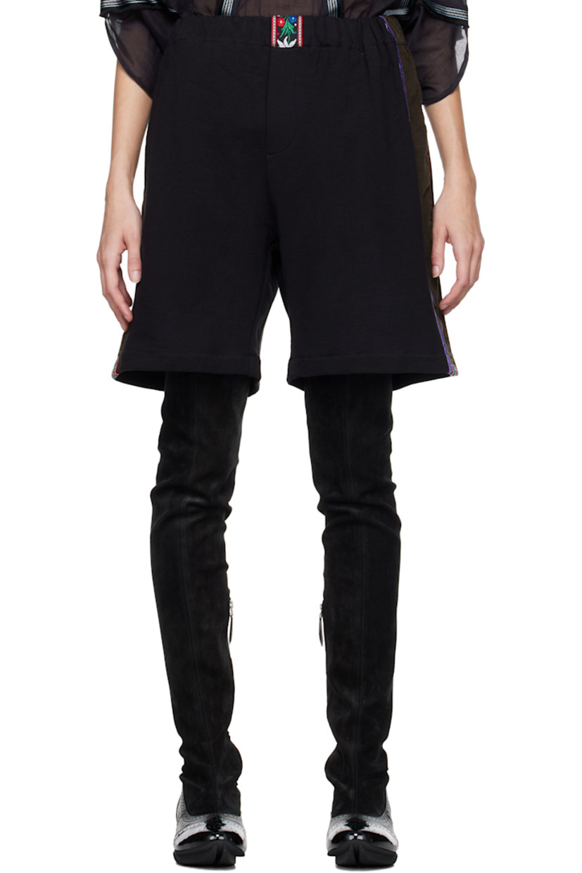 French terry shorts. 

· Embroidered floral trim at elasticized waistband and cuffs
· Mock-fly
· Corduroy and velvet trim at outseams 

Supplier color: Comet