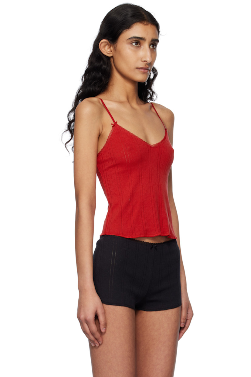 GOTS-certified organic cotton pointelle camisole.

· Scalloped lace trim at scoop neck
· Bow accents at front
· Cropped hem
· Adjustable elasticized spaghetti straps

Supplier color: Red