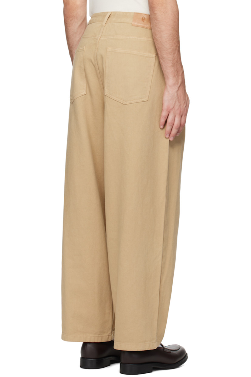 Wide-leg overdyed non-stretch denim jeans.

· Belt loops
· Four-pocket styling
· Zip-fly
· Pleats at front
· Logo patch at back waistband

Supplier color: Beige