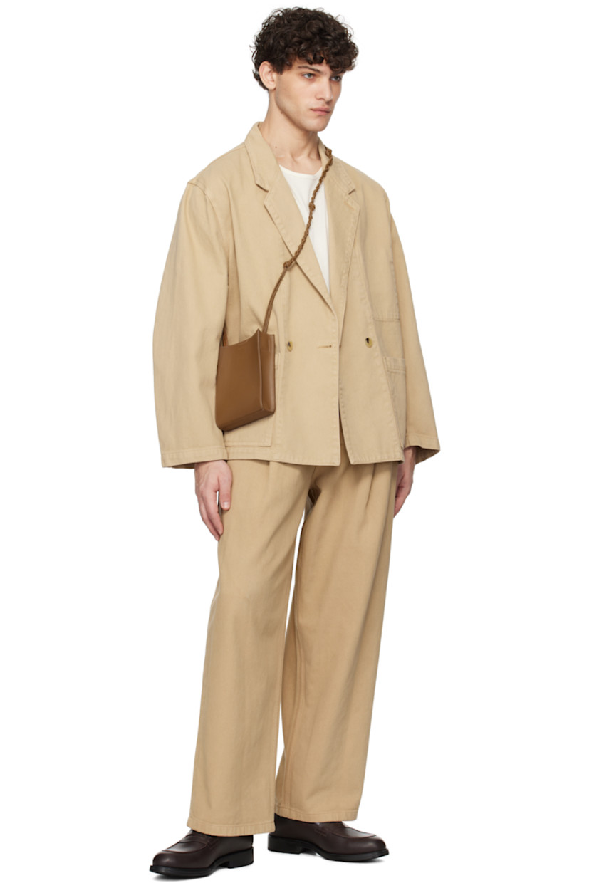 Wide-leg overdyed non-stretch denim jeans.

· Belt loops
· Four-pocket styling
· Zip-fly
· Pleats at front
· Logo patch at back waistband

Supplier color: Beige