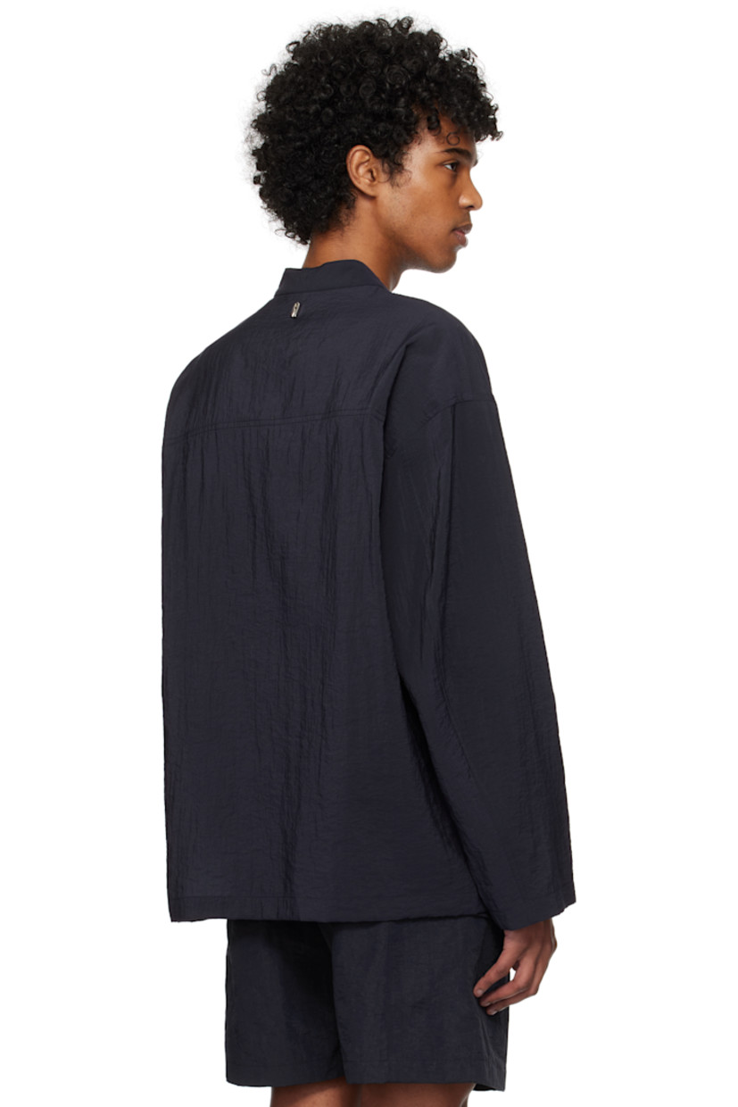 Crinkled plain-woven rayon-blend shirt. 

· Button tab at band collar
· Keyhole at chest
· Patch pocket
· Dropped shoulders
· Logo hardware at back collar
· Twin pleats at yoke

Supplier color: Navy