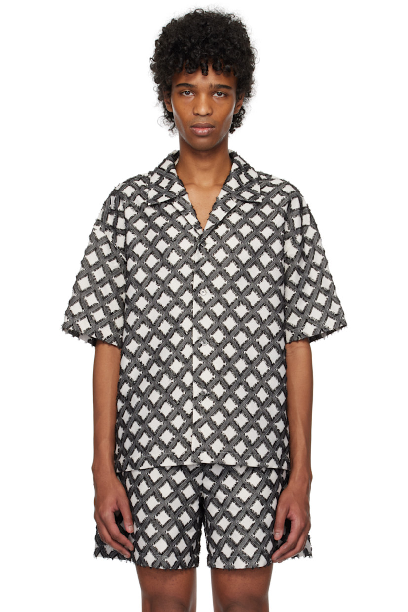 Polyester- and cotton-blend twill shirt. Jacquard pattern and frayed edges throughout.

· Open spread collar
· Button closure
· Vented side seams 
· Dropped shoulders
· Logo hardware at back collar
· Keeper loop and twin pleats at yoke 

Supplier color: Black