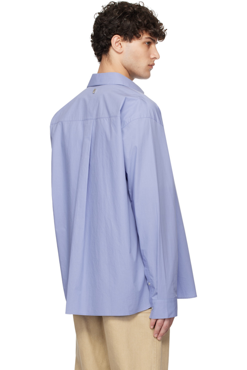 Cotton poplin shirt. 

· Spread collar
· Press-stud closure
· Shirttail hem
· Adjustable single-press-stud barrel cuffs
· Logo hardware at back collar
· Box pleat at back yoke

Supplier color: Blue