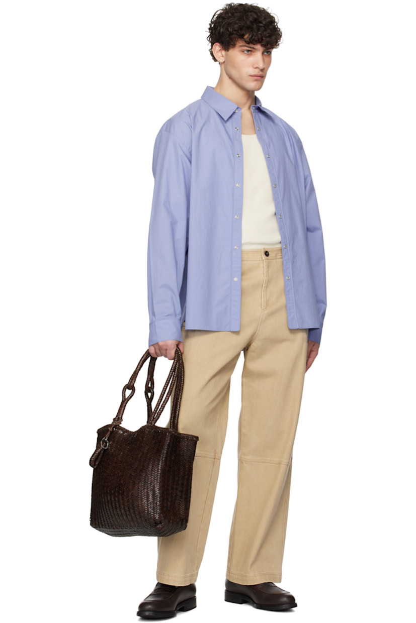 Cotton poplin shirt. 

· Spread collar
· Press-stud closure
· Shirttail hem
· Adjustable single-press-stud barrel cuffs
· Logo hardware at back collar
· Box pleat at back yoke

Supplier color: Blue