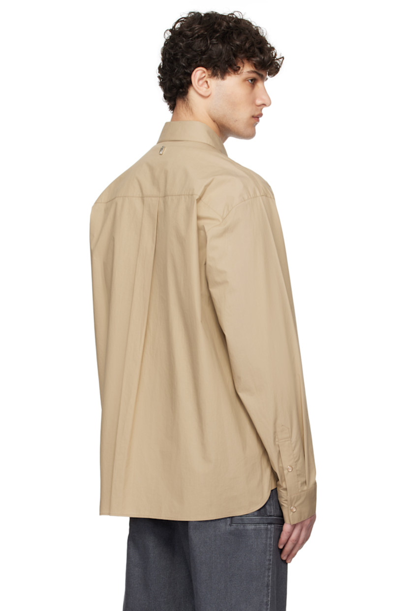 Cotton poplin shirt. 

· Spread collar
· Press-stud closure
· Shirttail hem
· Adjustable single-press-stud barrel cuffs
· Logo hardware at back collar
· Box pleat at back yoke

Supplier color: Beige