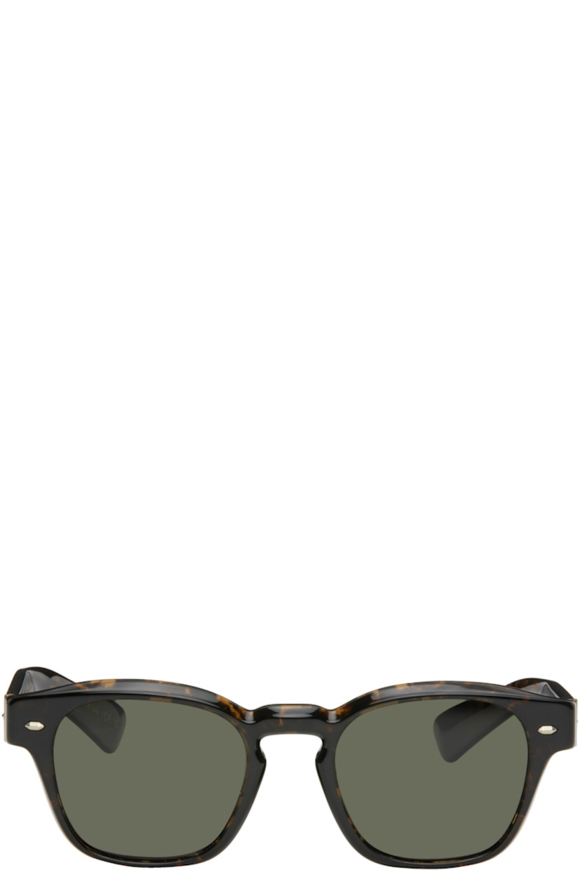 Handcrafted square semi-transparent tortoiseshell acetate-frame sunglasses in brown.

· Polarized khaki lenses
· 100% UVA/UVB protection
· Keyhole bridge
· Integrated nose pads
· Exposed core wires
· Includes pouch
· Size: 50.21 145

Supplier color: Walnut tortoise