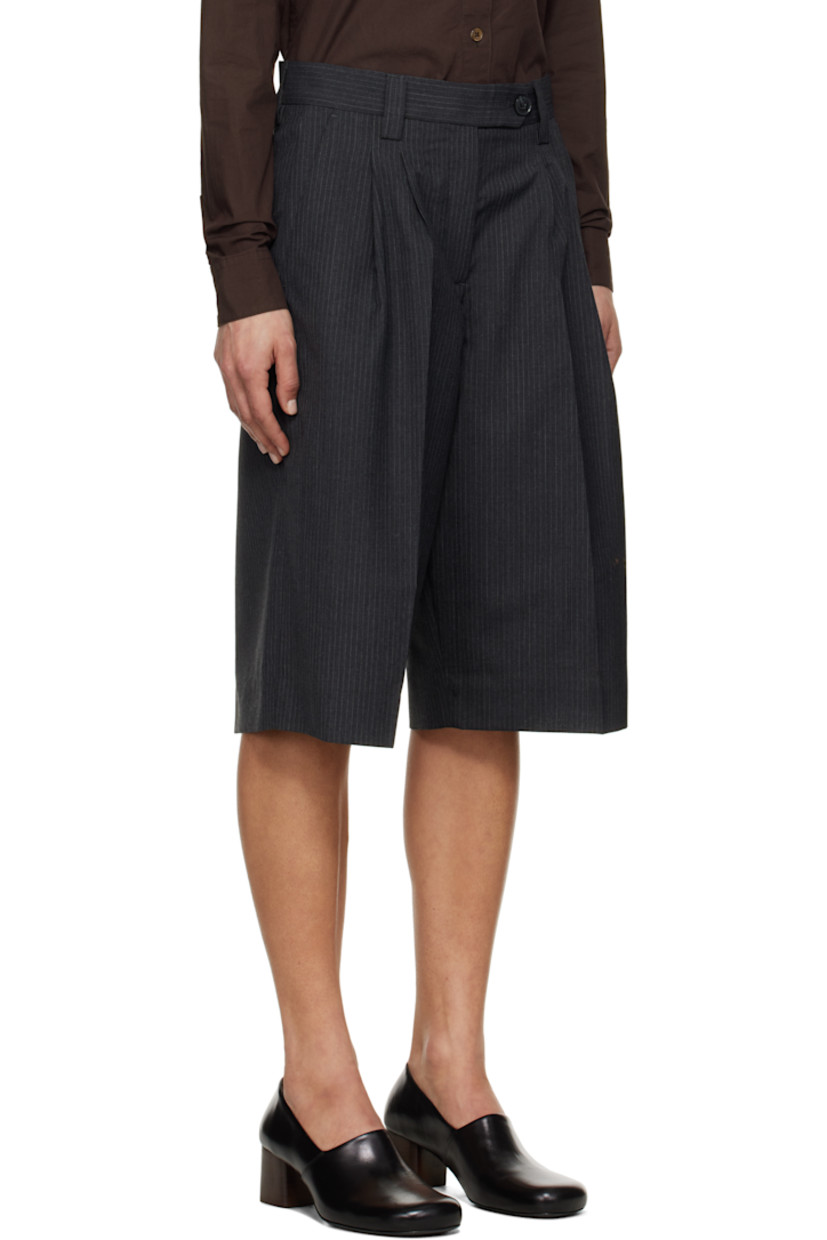 Wide-leg deadstock polyester- and virgin wool-blend twill shorts. Pinstripes throughout.

· Mid-rise
· Belt loops
· Four-pocket styling
· Zip fly
· Pleats at front
· Creased legs
· Darts at back waistband

Supplier color: Dark grey pinstripe