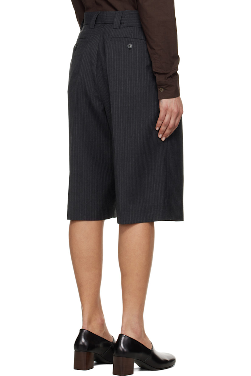 Wide-leg deadstock polyester- and virgin wool-blend twill shorts. Pinstripes throughout.

· Mid-rise
· Belt loops
· Four-pocket styling
· Zip fly
· Pleats at front
· Creased legs
· Darts at back waistband

Supplier color: Dark grey pinstripe