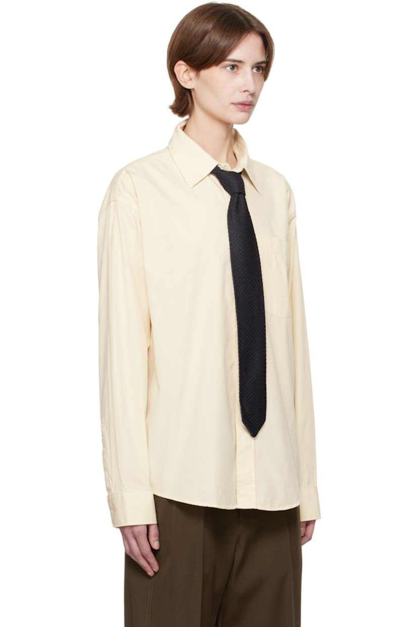 Garment-washed deadstock cotton poplin shirt. 

· Spread collar
· Button closure
· Patch pocket
· Shirttail hem
· Dropped shoulders
· Single-button barrel cuffs
· Box pleat at yoke

Supplier color: Faded yellow