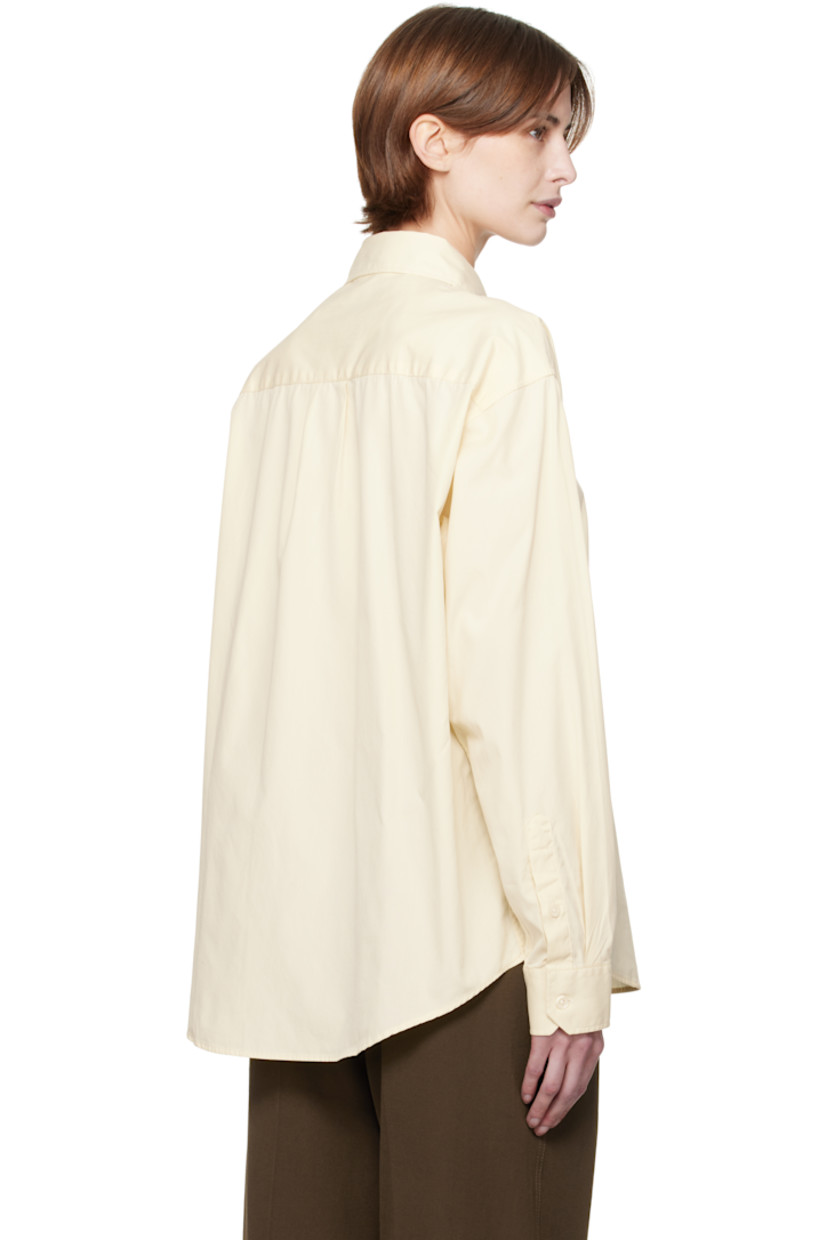 Garment-washed deadstock cotton poplin shirt. 

· Spread collar
· Button closure
· Patch pocket
· Shirttail hem
· Dropped shoulders
· Single-button barrel cuffs
· Box pleat at yoke

Supplier color: Faded yellow
