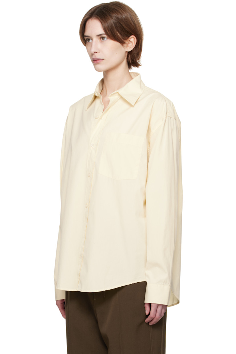 Garment-washed deadstock cotton poplin shirt. 

· Spread collar
· Button closure
· Patch pocket
· Shirttail hem
· Dropped shoulders
· Single-button barrel cuffs
· Box pleat at yoke

Supplier color: Faded yellow