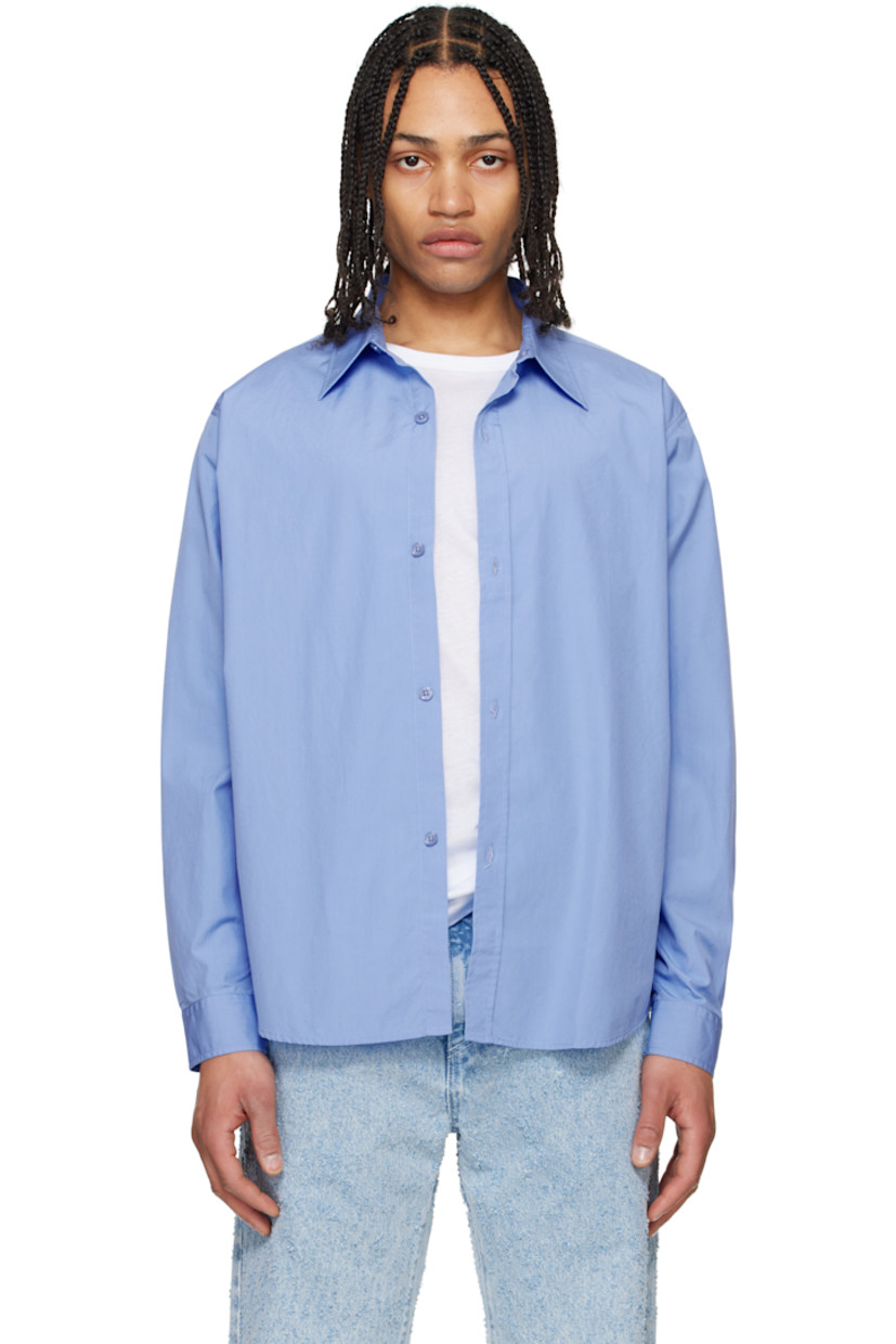 Garment-washed cotton poplin shirt. 

· Spread collar
· Button closure
· Shirttail hem
· Single-button barrel cuffs
· Locker loop at interior collar

Supplier color: Office blue