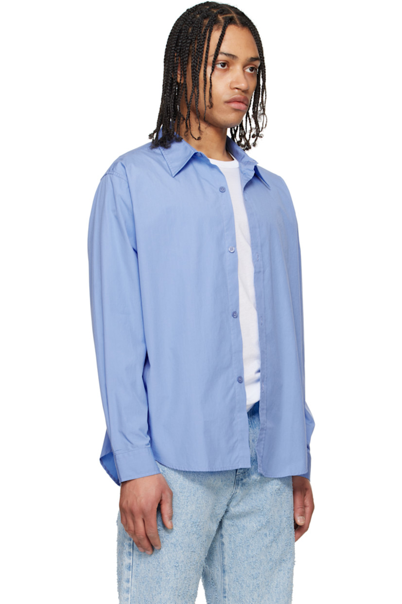 Garment-washed cotton poplin shirt. 

· Spread collar
· Button closure
· Shirttail hem
· Single-button barrel cuffs
· Locker loop at interior collar

Supplier color: Office blue