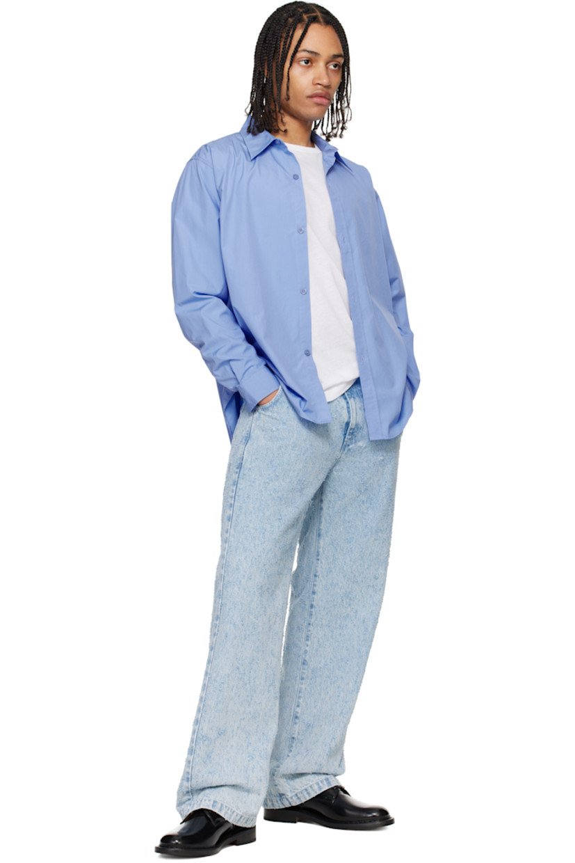 Garment-washed cotton poplin shirt. 

· Spread collar
· Button closure
· Shirttail hem
· Single-button barrel cuffs
· Locker loop at interior collar

Supplier color: Office blue