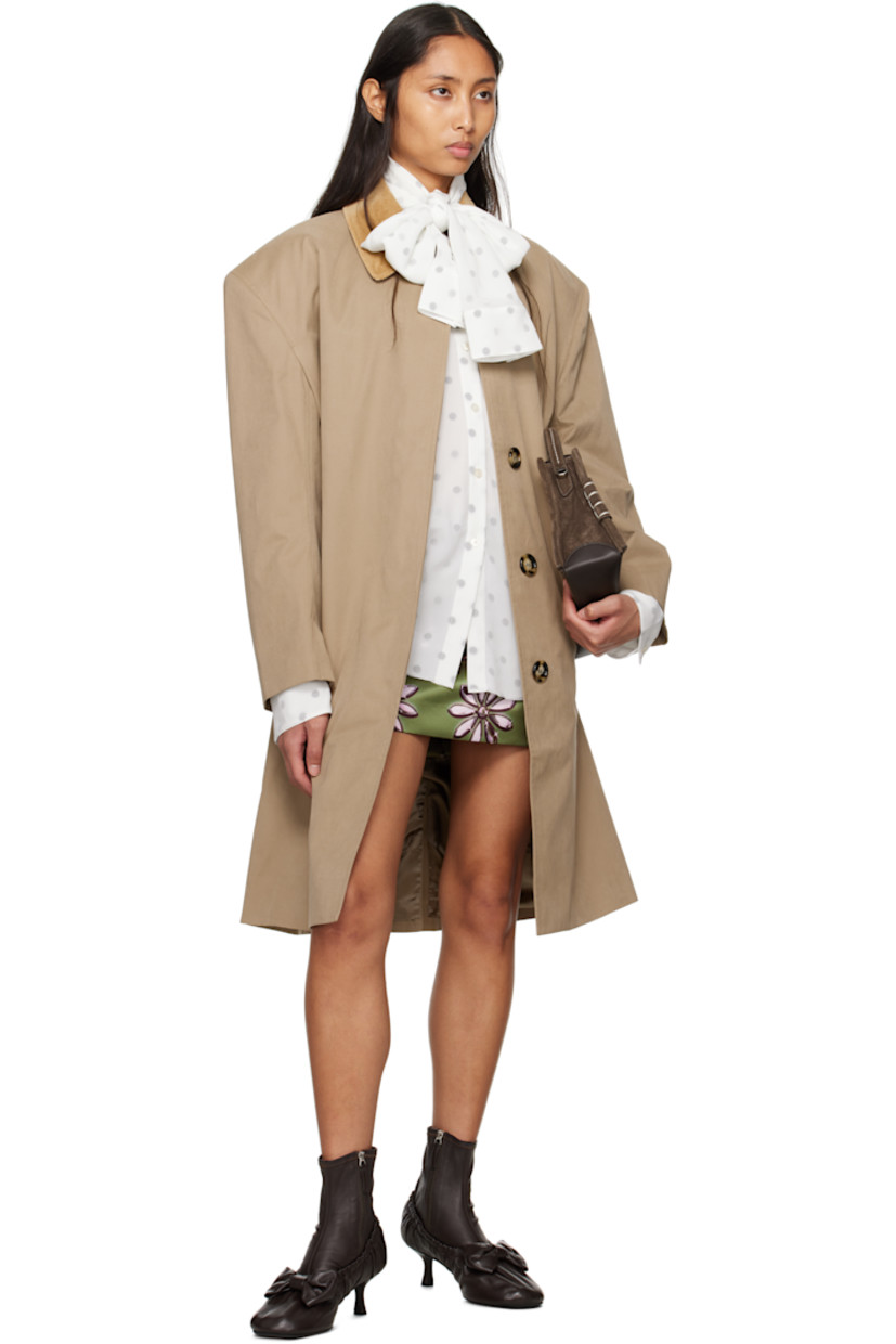 Polyester- and cotton-blend canvas coat.

· Corduroy spread collar
· Concealed button closure
· Welt pockets
· Padded shoulders
· Button tab at cuffs
· Central vent at back hem
· Patch pocket at interior
· Full satin lining

Supplier color: Sand