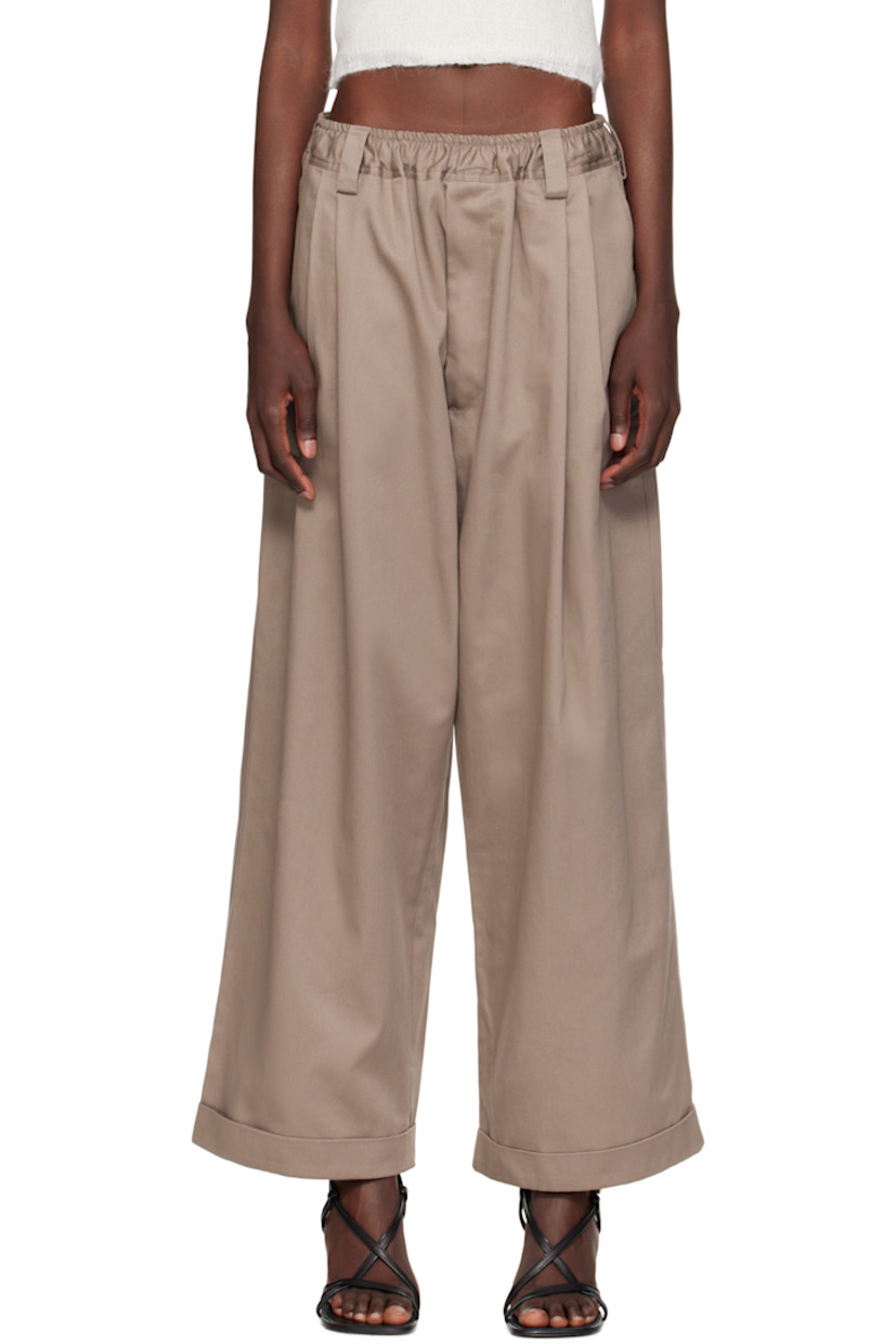 Cotton gabardine trousers.

· Concealed drawstring at elasticized waistband
· Belt loops
· Four-pocket styling
· Mock fly
· Pleats at front
· Rolled cuffs
· Logo patch at back pocket

Supplier color: Dark clay