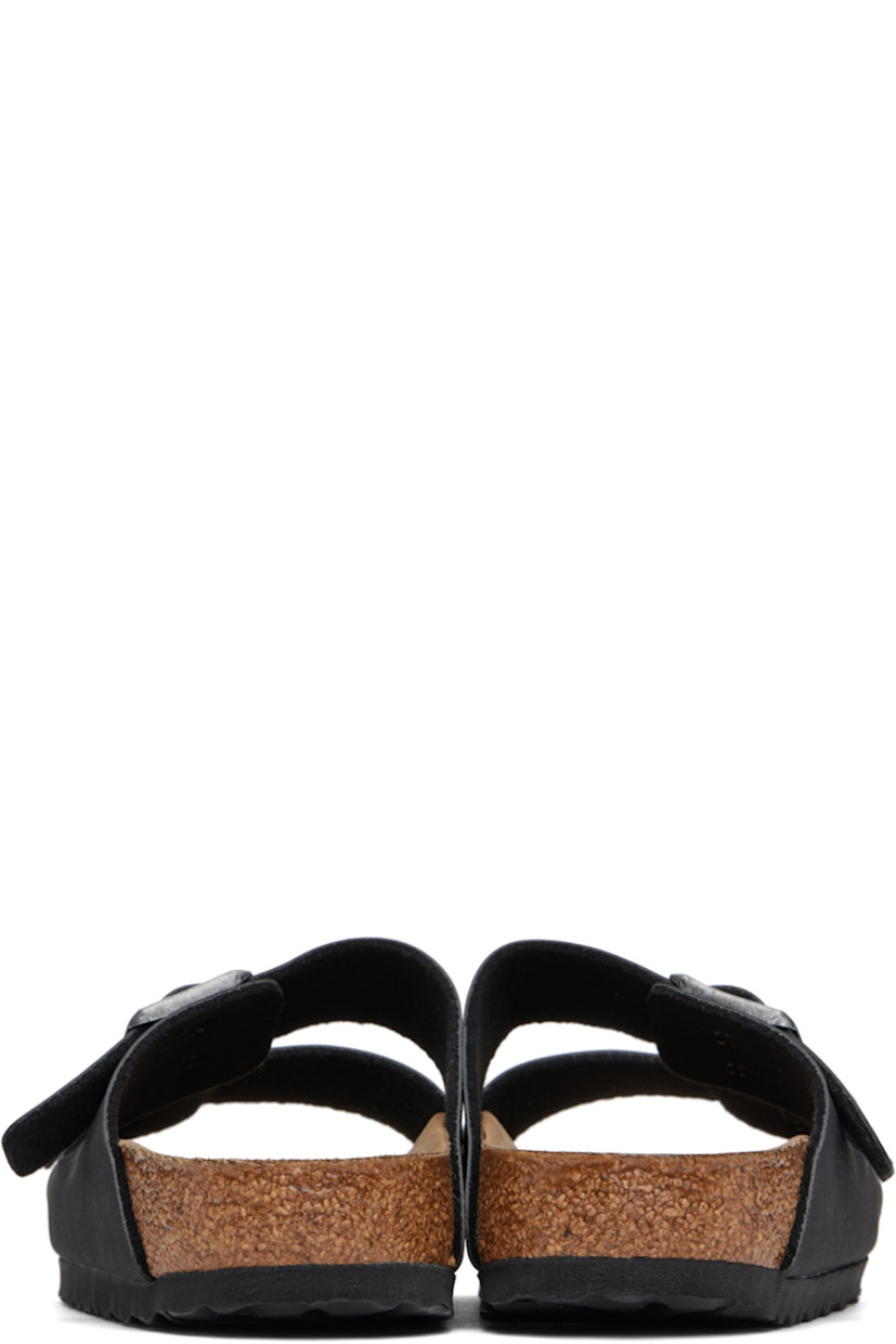 Buffed Birkibuc® faux-leather slip-on sandals in black.

· Open toe
· Pin-buckle straps at vamp
· Logo embossed at inner side
· Logo printed at molded footbed
· Microfiber lining
· Cork-latex midsole
· Treaded rubber sole
· Logo-engraved antiqued silver-tone hardware

Supplier color: Black