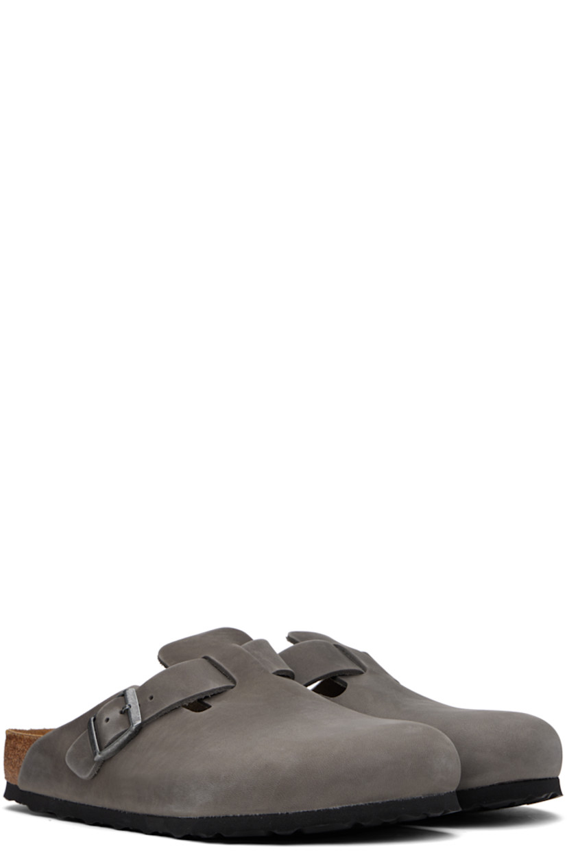 Oiled and waxed leather slip-on loafers in gray.

· Pin-buckle strap at vamp
· Logo embossed at inner side
· Logo printed at molded footbed
· Suede lining
· Cork-latex midsole
· Treaded rubber sole
· Logo-engraved antiqued gunmetal-tone hardware

Supplier color: Iron
