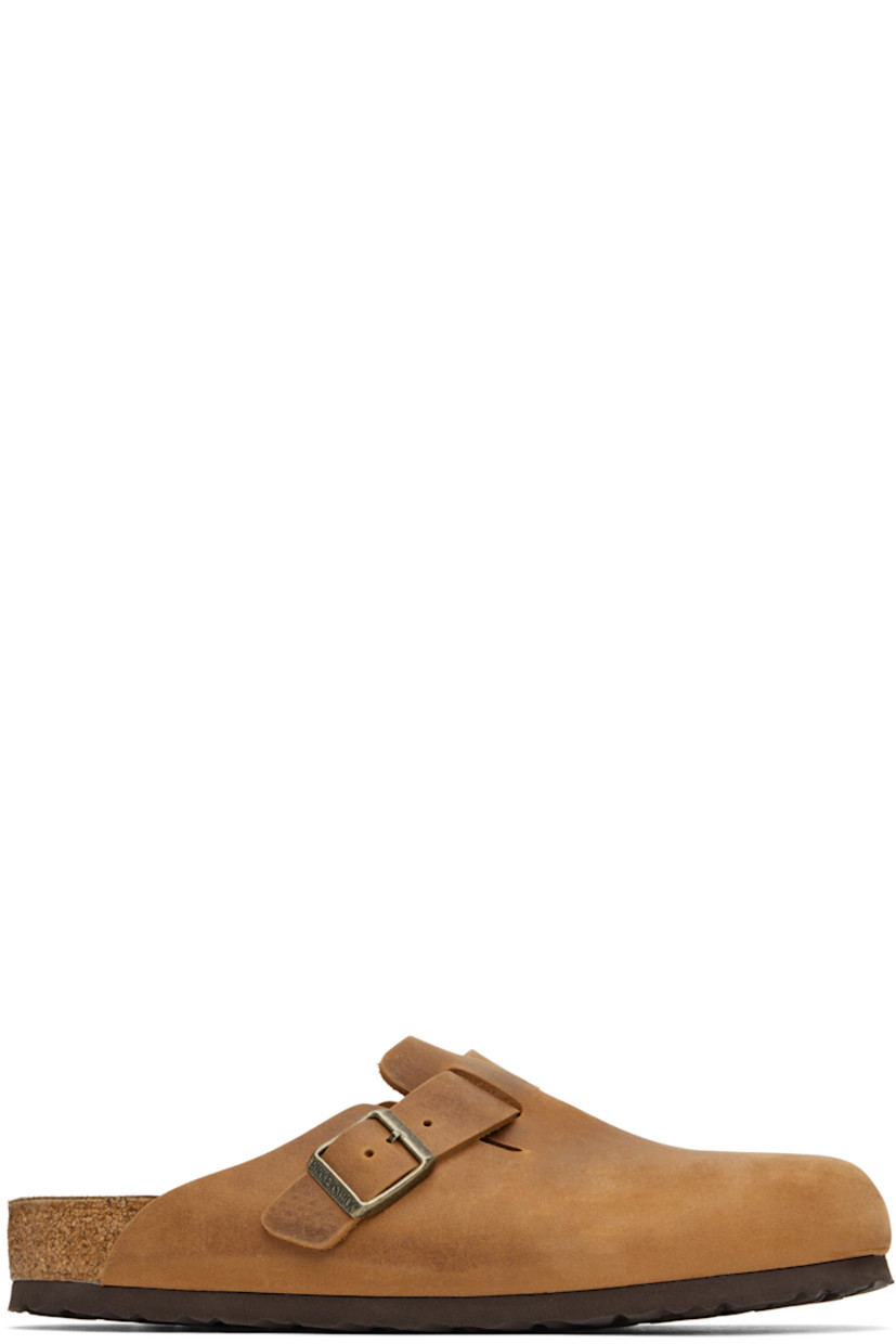 Oiled leather slip-on loafers in tan.

· Adjustable pin-buckle strap at vamp
· Logo embossed at inner side
· Logo printed at molded suede footbed
· Cork-latex midsole
· Treaded rubber sole
· Logo-engraved antiqued gold-tone hardware

Supplier color: Cognac