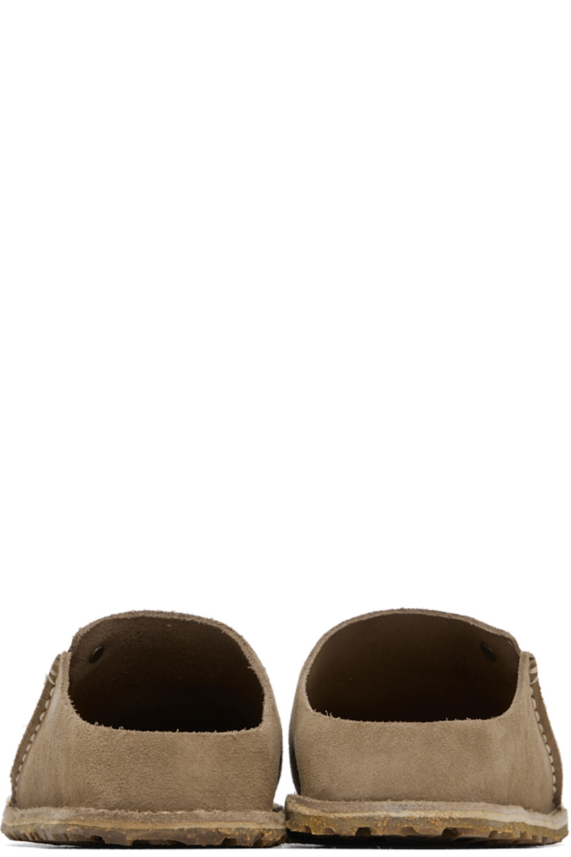 Suede slip-on loafers in beige.

· Logo hardware at vamp
· Pinched seam at outer side
· Logo embossed at inner side
· Logo printed at molded suede footbed
· Cork-latex midsole
· Treaded rubber sole
· Contrast stitching in white

Supplier color: Gray taupe
