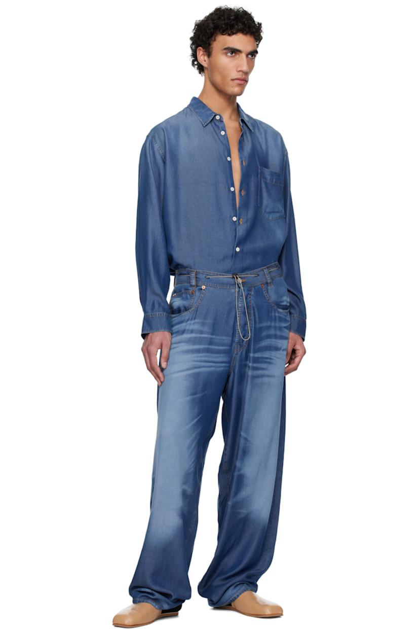 Lightweight lyocell twill shirt. Trompe-l'œil denim pattern printed throughout.

· Spread collar
· Button closure
· Patch pocket at chest
· Buttoned barrel cuffs
· Pleats at back yoke 
· Adjustable button tabs at back hem 
· Contrast stitching in tan

Supplier color: Indigo