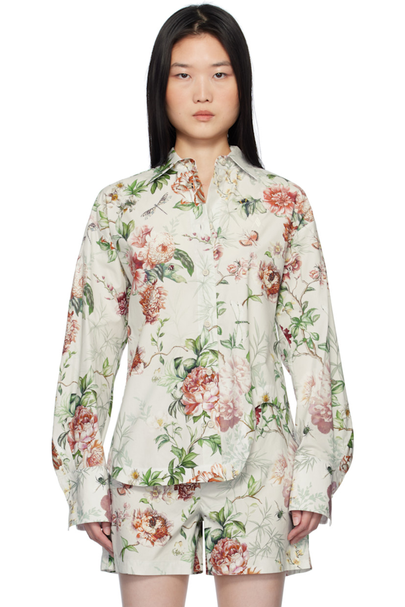 Cotton poplin shirt. Floral pattern printed throughout.

· Spread collar
· Button closure
· Logo embroidered at chest 
· Asymmetric shirttail hem
· Dropped shoulders
· Pleated single-button barrel cuffs

Supplier color: Ivory