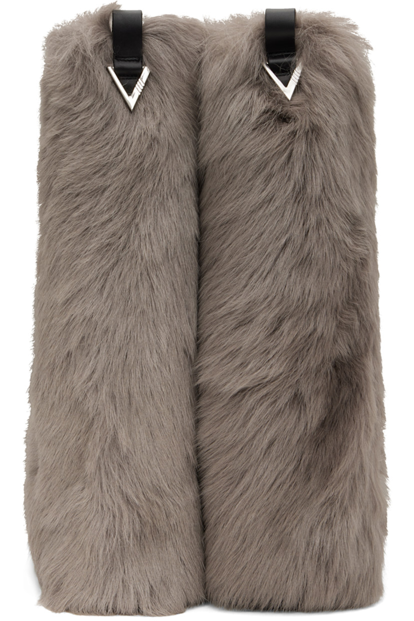 Mid-calf lambskin shearling boots in taupe.

· Layered construction
· Square toe
· Pull-loop and logo hardware at heel tab
· Stacked rubber heel and midsole
· Treaded rubber sole
· Heel: H1.5"

Supplier color: Taupe