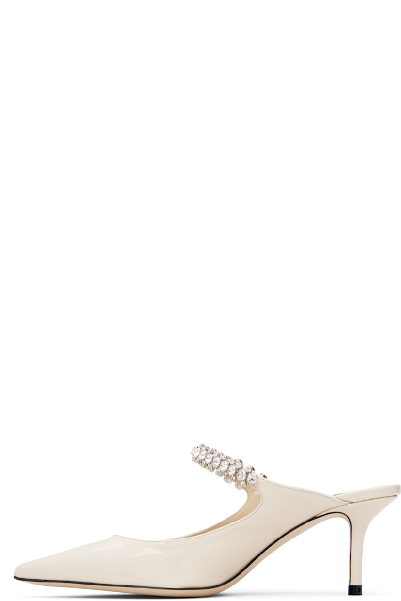 Patent leather mules.

· Pointed toe
· Crystal-cut accents at fixed strap
· Logo patch at grained leather footbed
· Covered stiletto heel
· Nubuck sole
· Heel: H2.5"

Supplier color: Linen
