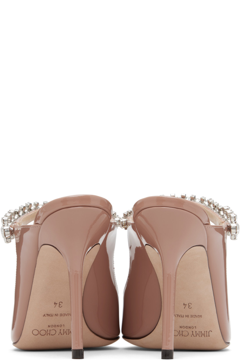 Patent leather mules.

· Pointed toe
· Crystal-cut accents at fixed strap
· Logo patch at grained leather footbed
· Covered stiletto heel
· Nubuck sole
· Heel: H4"

Supplier color: Ballet pink