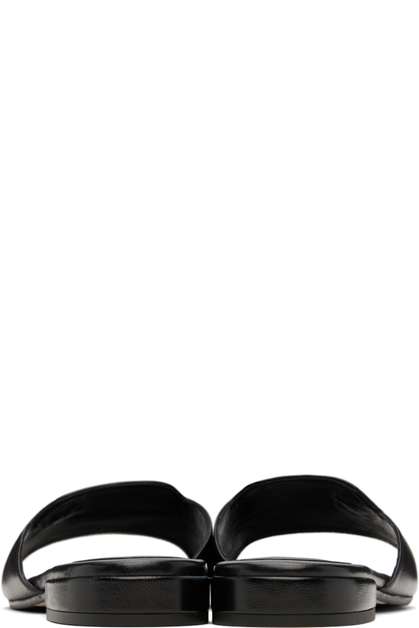 Buffed leather slip-on sandals in black. 

· Open square toe
· Strap with logo hardware at vamp
· Logo embossed at molded footbed 
· Covered block heel with rubber injection
· Nubuck and treaded rubber sole

Supplier color: Black
