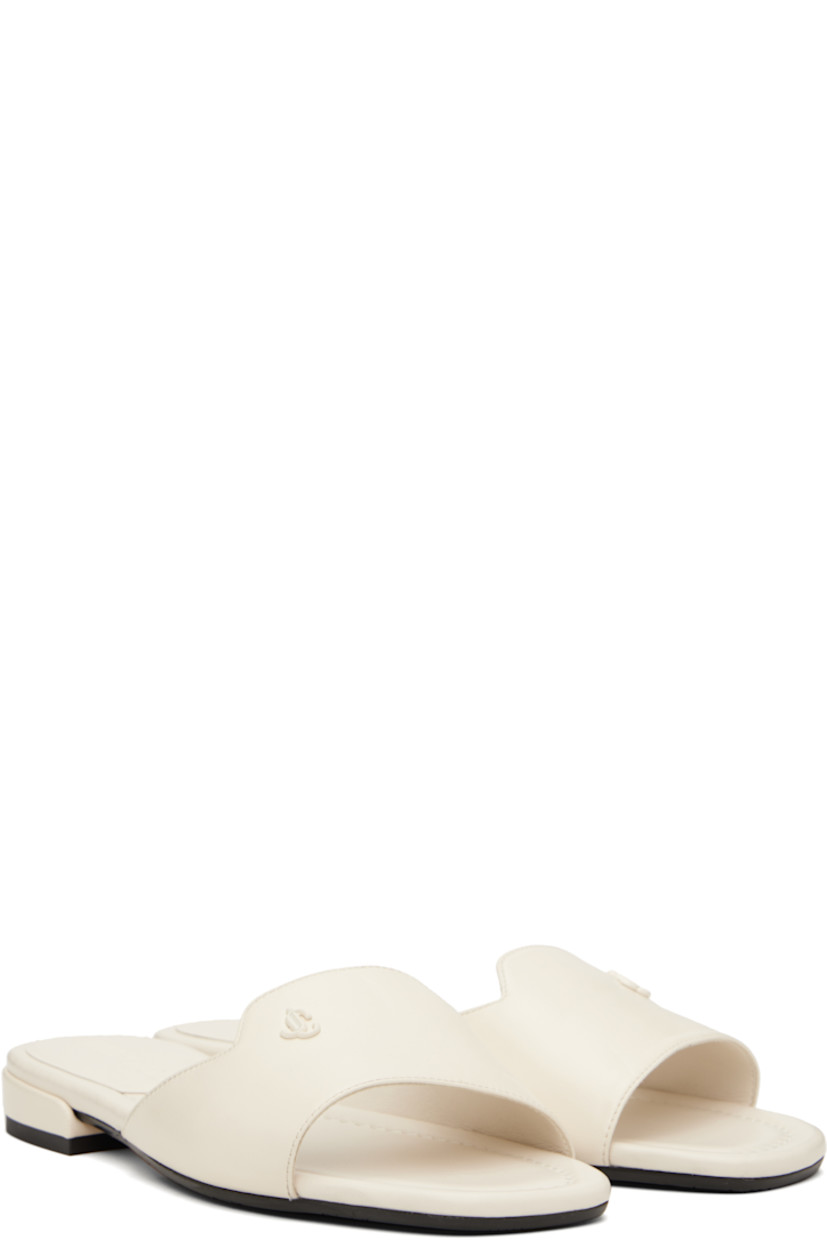 Buffed leather slip-on sandals in off-white. 

· Open square toe
· Strap with logo hardware at vamp
· Logo embossed at molded footbed 
· Covered block heel with rubber injection
· Nubuck and treaded rubber sole

Supplier color: Latte