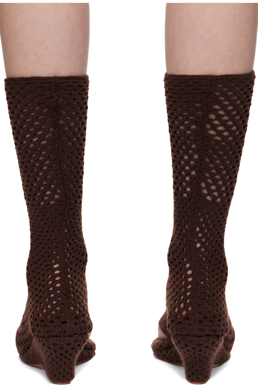 Open-knit sock-style heeled sandals in brown. 

· Elasticized thong-style strap at vamp
· Knit-covered wedge heel 
· Leather sole 
· Heel: H2.5"

Supplier color: Coffee