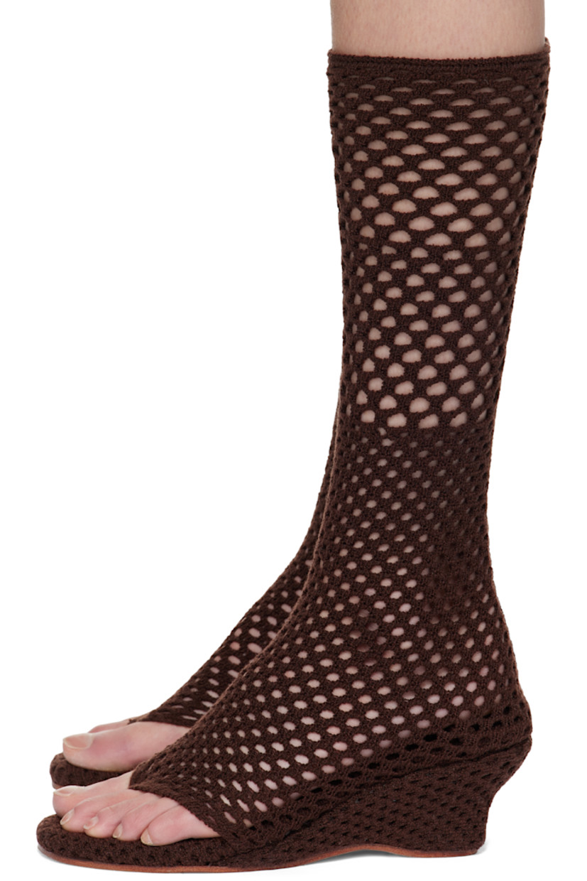 Open-knit sock-style heeled sandals in brown. 

· Elasticized thong-style strap at vamp
· Knit-covered wedge heel 
· Leather sole 
· Heel: H2.5"

Supplier color: Coffee