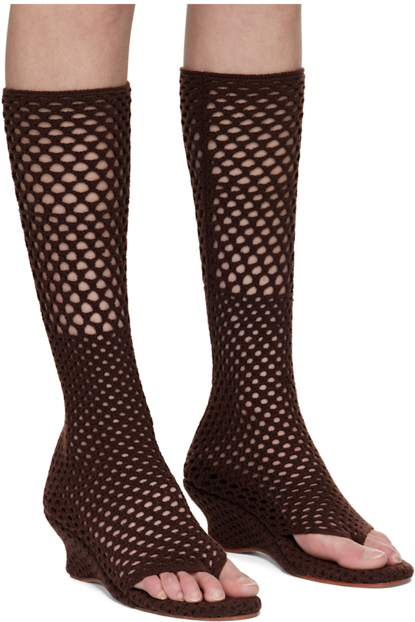 Open-knit sock-style heeled sandals in brown. 

· Elasticized thong-style strap at vamp
· Knit-covered wedge heel 
· Leather sole 
· Heel: H2.5"

Supplier color: Coffee