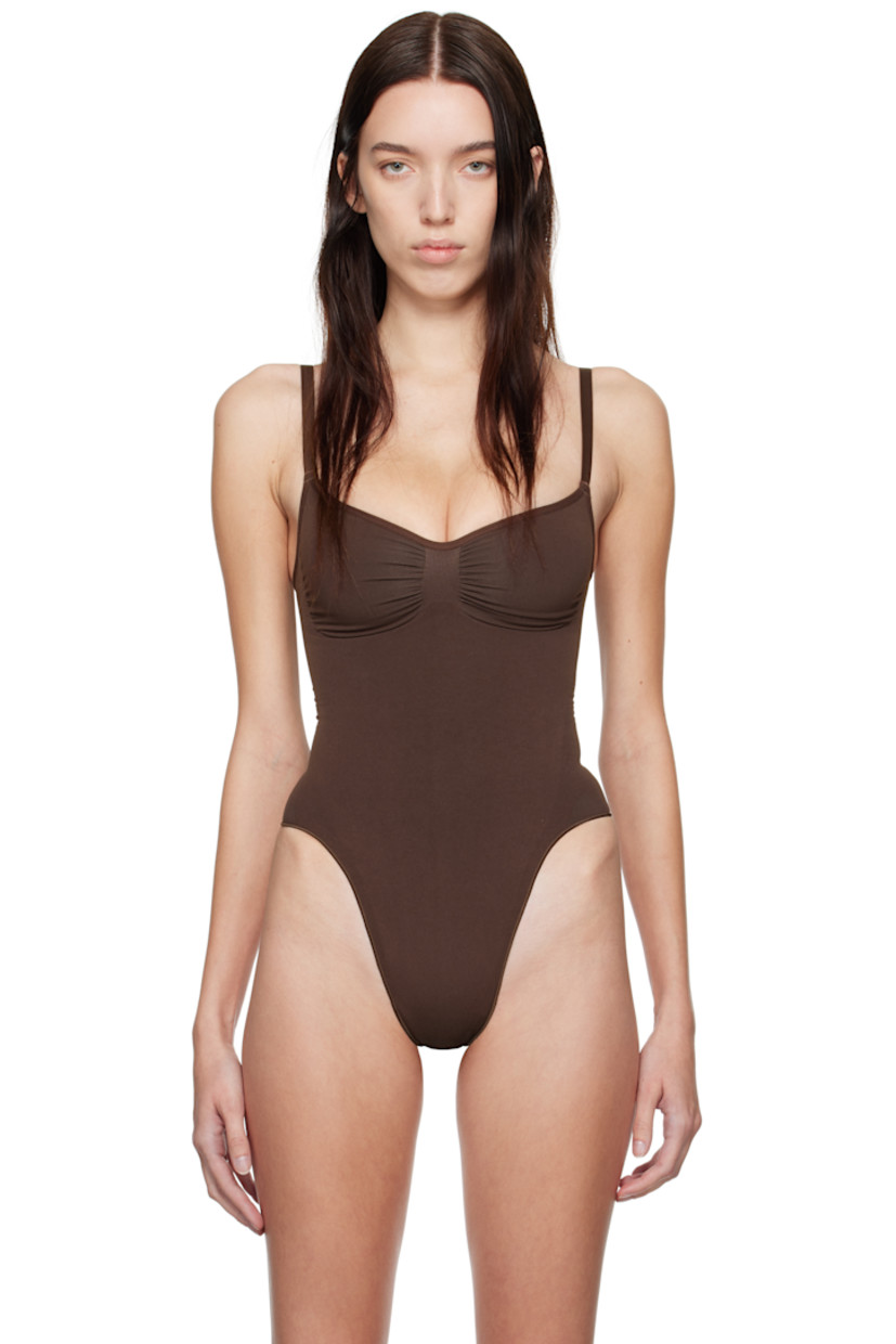 Stretch recycled nylon-blend jersey bodysuit.

· Sweetheart neck
· Ruching at chest
· High-compression waist
· Press-stud closure at bottom
· Adjustable elasticized spaghetti straps
· Partial cotton lining

Supplier color: Cocoa