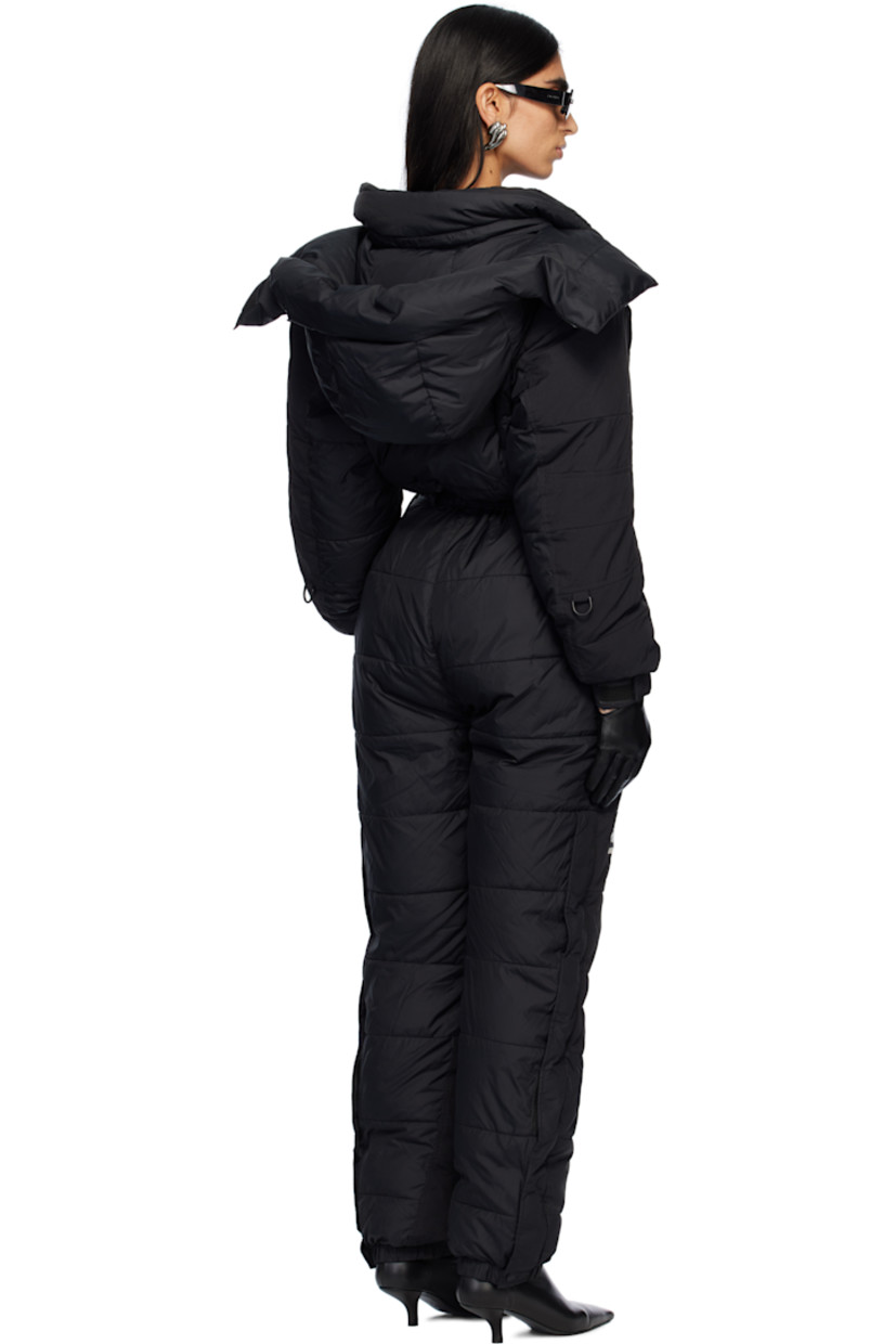 Down-filled and quilted nylon taffeta snow suit.

· Bungee-style drawstring at detachable hood 
· Funnel neck
· Concealed zip closure and velcro placket
· Logo embroidered at chest, leg, and back
· Zip pockets
· Elasticized waist
· Press-stud tabs at elasticized hem 
· Concealed zip vent at outseams
· Text embroidered at sleeve
· Velcro tab at cuffs
· Fully lined

Part of The North Face x SKIMS collaboration.

Available exclusively at SSENSE.

Supplier color: Onyx

Fill: 85% down, 15% waterfowl feathers.